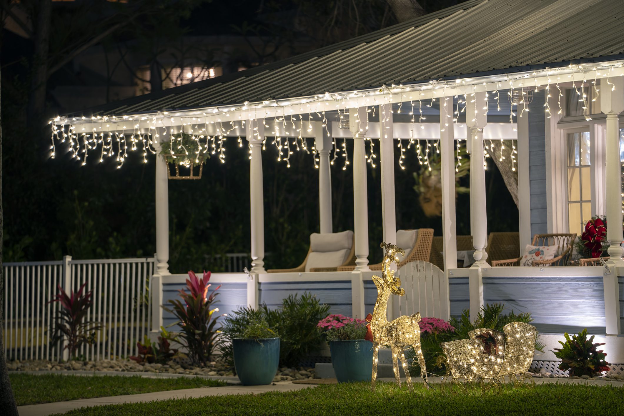 House with festive lights and decorations outside.