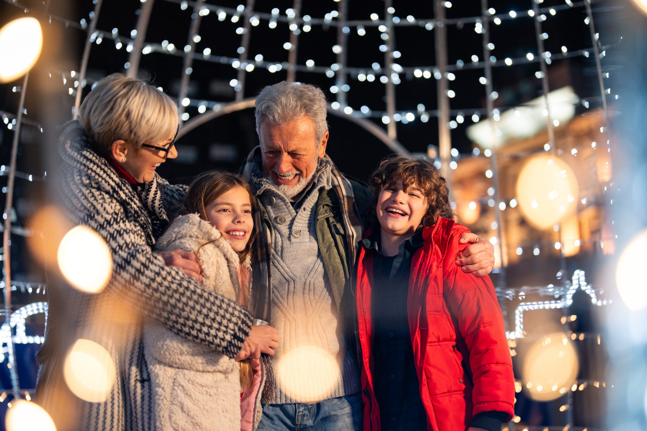Family enjoying festive lights at night.